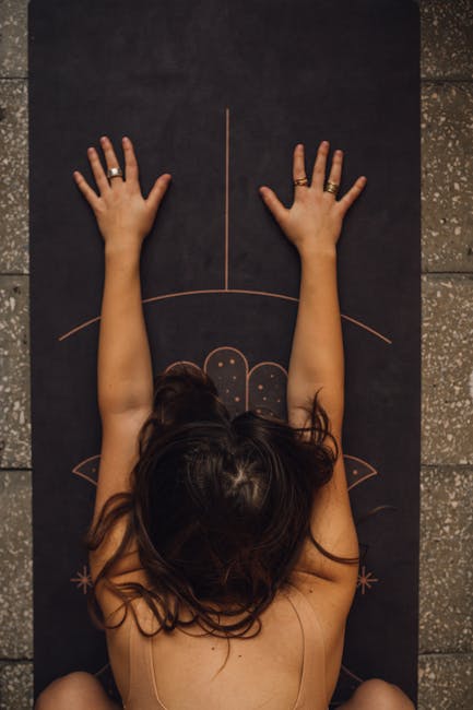 Person doing a gentle stretching yoga pose on a mat