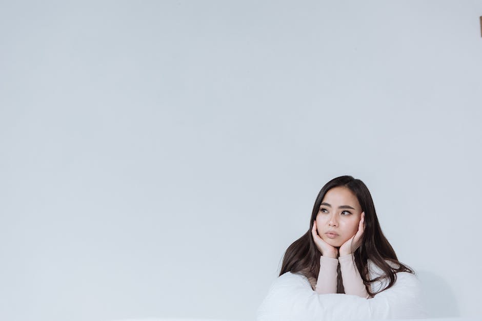 Serene woman in a meditative pose in a light-filled space
